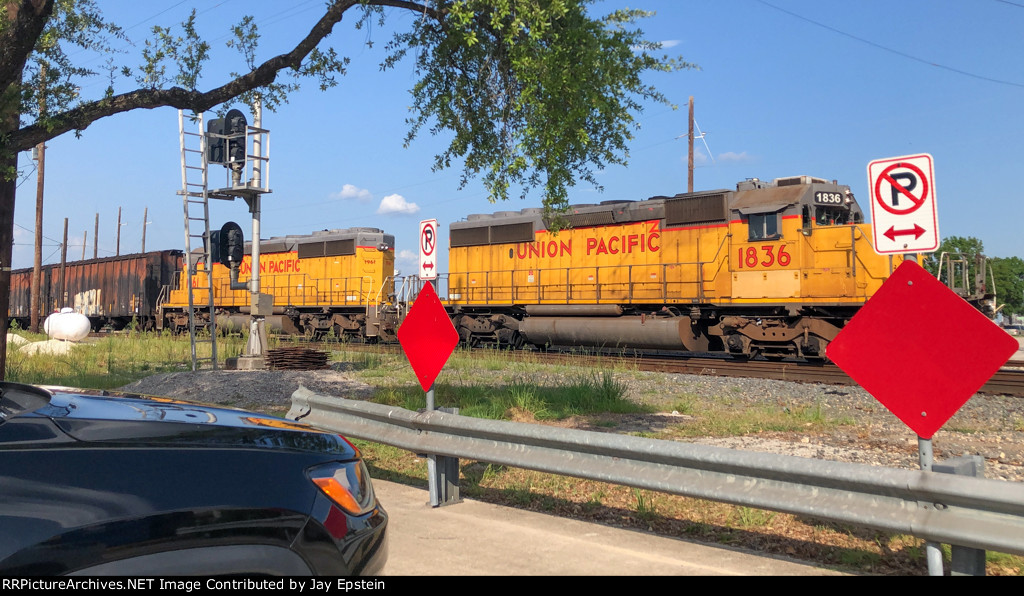 Two SD40-2s lead a train off the Neches River Lift Bridge